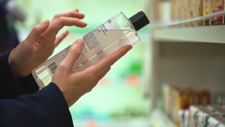 Person reading a fragrance-free ingredients label.